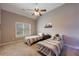 A nice bedroom includes a vaulted ceiling, a ceiling fan and two beds with striped blankets at 652 Pathview Ct, Dacula, GA 30019