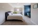 A charming bedroom features gray carpet and a small niche study area painted with a blue accent wall at 652 Pathview Ct, Dacula, GA 30019