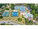 Aerial view showcasing the community pool and tennis courts for recreation and leisure activities at 652 Pathview Ct, Dacula, GA 30019