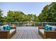 Relaxing outdoor deck area with wicker chairs, offering a peaceful view of lush greenery and serene pond at 652 Pathview Ct, Dacula, GA 30019