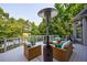 Inviting deck with wicker furniture, featuring a cozy outdoor lounge area and a scenic view of the surrounding greenery at 652 Pathview Ct, Dacula, GA 30019