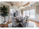 Formal dining room with decorative ceiling, wainscoting, and an adjoining music room at 652 Pathview Ct, Dacula, GA 30019