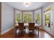 Cozy dining room featuring a large bay window and access to the outdoor deck at 652 Pathview Ct, Dacula, GA 30019