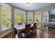 Bright dining room with large windows, hardwood floors, and a view of the outdoors at 652 Pathview Ct, Dacula, GA 30019