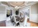 Dining room with an elegant tray ceiling and access to the living room at 652 Pathview Ct, Dacula, GA 30019
