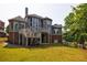 Stunning home exterior with multiple decks, a manicured lawn, and serene lake views at 652 Pathview Ct, Dacula, GA 30019