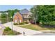 Charming brick home with well-manicured lawn, a pond view, and a welcoming curb appeal at 652 Pathview Ct, Dacula, GA 30019