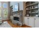 Close-up of a stone fireplace flanked by built-in shelving and cabinets at 652 Pathview Ct, Dacula, GA 30019