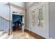 Elegant foyer with double doors and a view into the music room with a grand piano at 652 Pathview Ct, Dacula, GA 30019