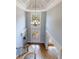 Grand foyer featuring a spiral staircase, chandelier, and double doors at 652 Pathview Ct, Dacula, GA 30019