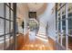 Grand foyer with curved staircase, hardwood floors, and abundant natural light at 652 Pathview Ct, Dacula, GA 30019