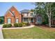 Elegant brick home with manicured lawn, beautiful landscaping, and stone accents, exuding curb appeal at 652 Pathview Ct, Dacula, GA 30019