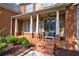Charming covered front porch with stately columns, stone accents, and a brick walkway at 652 Pathview Ct, Dacula, GA 30019