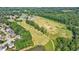 An aerial view of a well-maintained golf course surrounded by lush greenery and beautiful homes at 652 Pathview Ct, Dacula, GA 30019