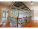 Second floor hallway overlooking the living room below with iron railing and a decorative ceiling at 652 Pathview Ct, Dacula, GA 30019