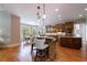 Spacious kitchen with hardwood floors, granite countertops, kitchen island, pendant lighting, and breakfast area at 652 Pathview Ct, Dacula, GA 30019