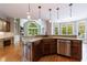 Spacious kitchen with hardwood floors, granite countertops, modern appliances, and abundant natural light at 652 Pathview Ct, Dacula, GA 30019