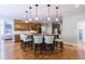 Spacious kitchen with a large island, wooden cabinets, granite countertops, and modern pendant lighting at 652 Pathview Ct, Dacula, GA 30019