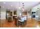 Spacious kitchen with hardwood floors, granite countertops, two islands, and pendant lighting at 652 Pathview Ct, Dacula, GA 30019