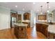 Spacious kitchen with hardwood floors, granite countertops, a kitchen island, and stainless steel appliances at 652 Pathview Ct, Dacula, GA 30019