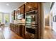 Gourmet kitchen featuring custom wood cabinets, granite countertops, and stainless steel appliances at 652 Pathview Ct, Dacula, GA 30019