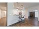 Open kitchen featuring a breakfast bar with pendant lighting, luxury vinyl plank floors, and stainless appliances at 652 Pathview Ct, Dacula, GA 30019