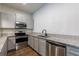 Updated kitchen featuring stainless steel appliances, granite countertops, and hardwood floors at 652 Pathview Ct, Dacula, GA 30019