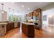 Spacious kitchen with hardwood floors, granite countertops, a kitchen island, and stainless steel appliances at 652 Pathview Ct, Dacula, GA 30019