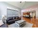 Open-concept living room with a kitchen view, featuring hardwood floors, a fireplace, and an airy atmosphere at 652 Pathview Ct, Dacula, GA 30019