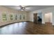 Bright living room with hardwood floors, ceiling fan, and a barn door entrance to a bedroom at 652 Pathview Ct, Dacula, GA 30019