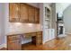 Cozy study with custom wooden desk and cabinets, a stone fireplace, hardwood floors, and natural light at 652 Pathview Ct, Dacula, GA 30019