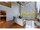 Spacious living room with soaring ceilings, large windows, and a stone fireplace at 652 Pathview Ct, Dacula, GA 30019