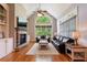 Comfortable living room with a stone fireplace, large windows, hardwood floors, and stylish furniture at 652 Pathview Ct, Dacula, GA 30019