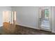 Open floorplan living room with hardwood floors and natural light from the sliding glass door at 652 Pathview Ct, Dacula, GA 30019