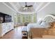 A spacious main bedroom with hardwood floors, decorative trey ceiling, and large windows at 652 Pathview Ct, Dacula, GA 30019