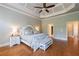 A spacious main bedroom with hardwood floors, decorative trey ceiling, and access to other rooms at 652 Pathview Ct, Dacula, GA 30019
