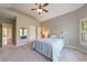 Bright main bedroom features shuttered windows, a ceiling fan, and ensuite bath with tiled shower at 652 Pathview Ct, Dacula, GA 30019