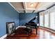 Music room with a grand piano, coffered ceilings, and natural light from large windows at 652 Pathview Ct, Dacula, GA 30019