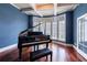 Music room showcasing a grand piano, bay window, and coffered ceiling at 652 Pathview Ct, Dacula, GA 30019
