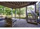 Covered patio features comfortable seating with lake views and direct access to backyard and lake at 652 Pathview Ct, Dacula, GA 30019