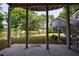 Tranquil outdoor patio with serene view of the lake, framed by mature trees and leading to lush lawn at 652 Pathview Ct, Dacula, GA 30019