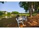 Inviting view of a peaceful pond with seating area and trees, perfect for relaxation and enjoying nature at 652 Pathview Ct, Dacula, GA 30019