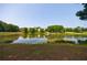 Scenic view of a pond reflecting trees and neighborhood homes against a clear blue sky at 652 Pathview Ct, Dacula, GA 30019