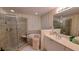 Luxurious bathroom featuring a glass-enclosed shower, soaking tub, and modern vanity at 3275 Lenox Ne Rd # 110, Atlanta, GA 30324