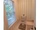 Cozy half-bathroom with a window, neutral tones, and classic fixtures at 3275 Lenox Ne Rd # 110, Atlanta, GA 30324