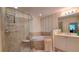 Bright bathroom featuring a glass enclosed shower, soaking tub, and dual sink vanity at 3275 Lenox Ne Rd # 110, Atlanta, GA 30324