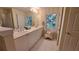 Well-lit bathroom featuring double sinks and a window for natural light at 3275 Lenox Ne Rd # 110, Atlanta, GA 30324