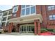 Building exterior showcasing the entrance, balcony, and a well-manicured landscape at 3275 Lenox Ne Rd # 110, Atlanta, GA 30324