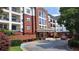 Beautiful exterior view of the building with well maintained landscaping and covered entrance with a brick facade at 3275 Lenox Ne Rd # 110, Atlanta, GA 30324