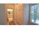 Hallway view with ample storage leading to a bathroom with natural light at 3275 Lenox Ne Rd # 110, Atlanta, GA 30324